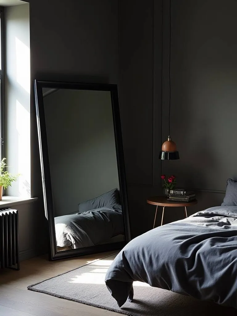 Bright and spacious black bedroom with a large black framed mirror reflecting daylight and enhancing the sense of openness.