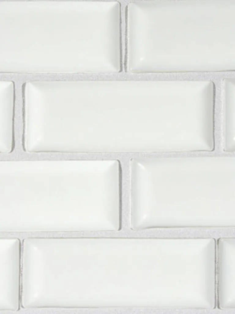 Close-up comparison of white subway tile backsplash with light grey grout and dark grey grout