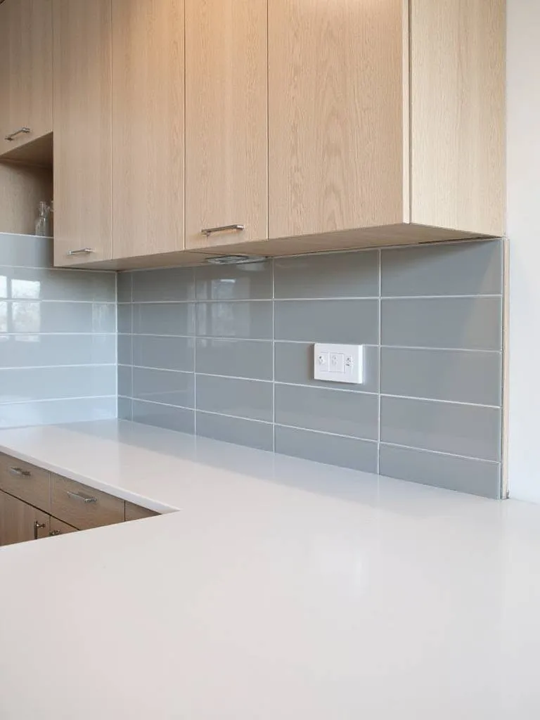 Modern kitchen with vertically stacked gray subway tile backsplash