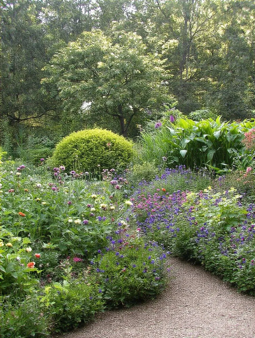 Top-down view of a detailed sun and shade map on graph paper with gardening tools on a wooden outdoor table under natural sunlight