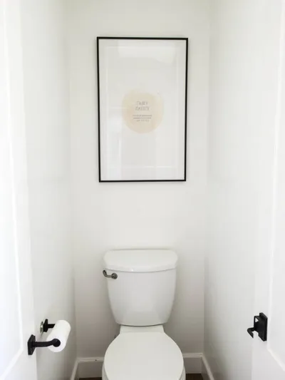 Small bathroom wall featuring a personalized art print adding character and style without clutter.