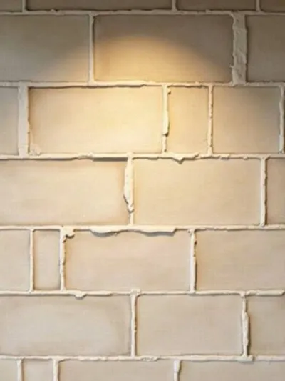 Detailed view of farmhouse kitchen backsplash featuring artisanal subway tiles in herringbone pattern, showcasing texture and craftsmanship.